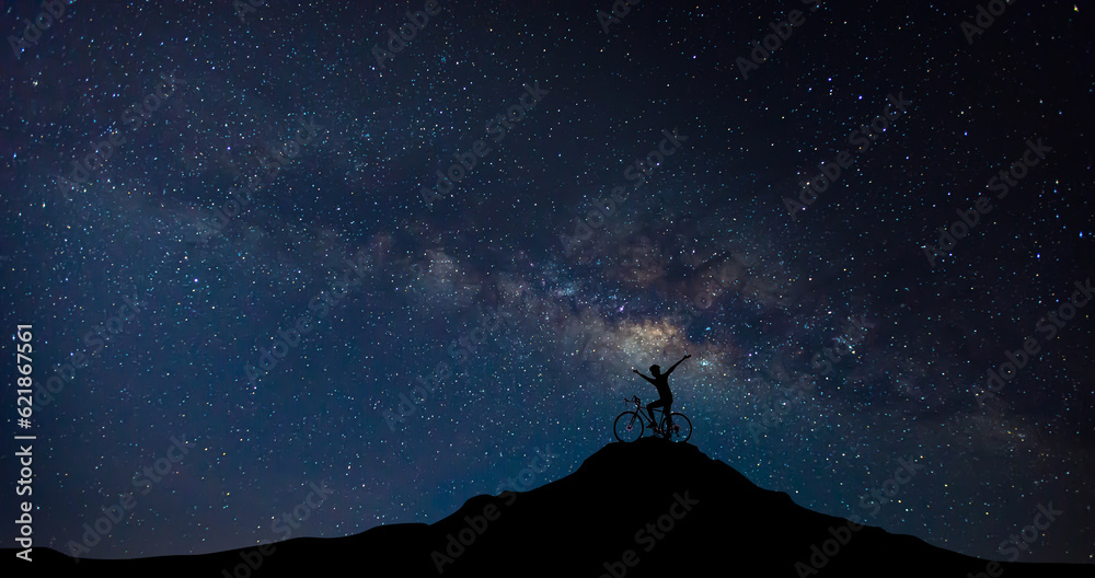 blury bicyclist and Bicycle silhouettes on the dark background of night. ride bicycle on milkyway background.