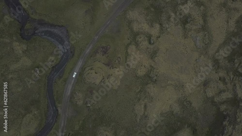 Toyota SUV driving on a mountain road towards Snaefellsjoekull glacier and mountain peaks, drone shot, Snaefellsnes peninsula, Iceland, Europe