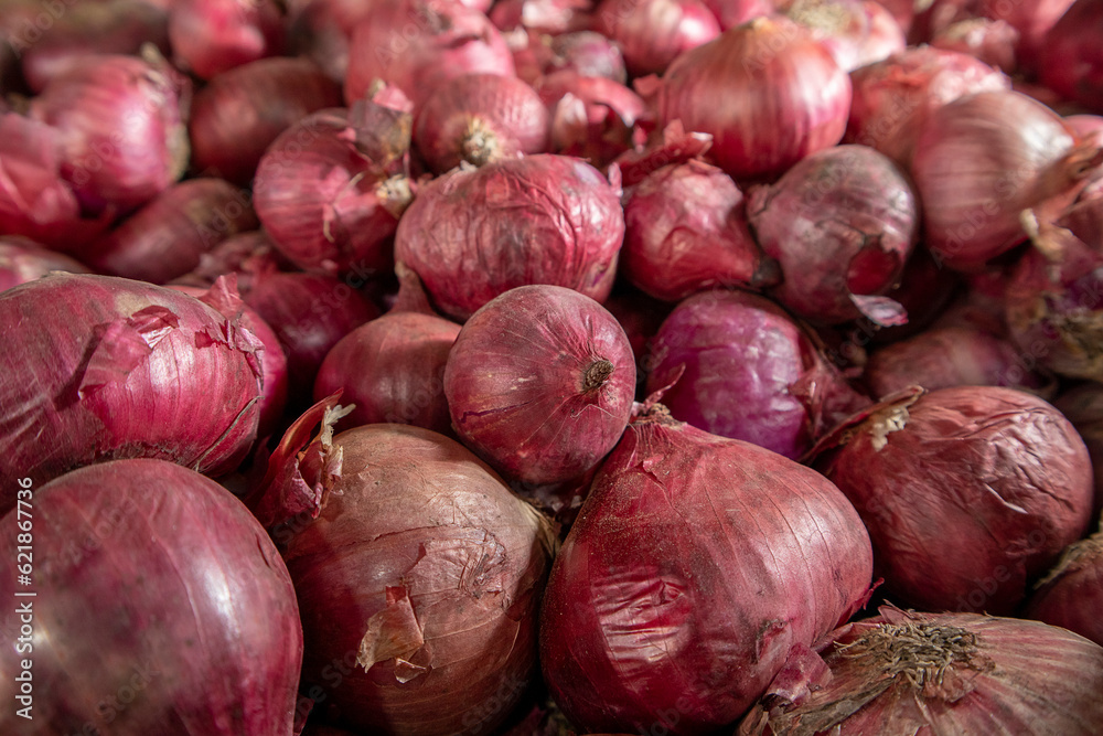 Red onions on display at a farmers market Red onions on display at a farmers market