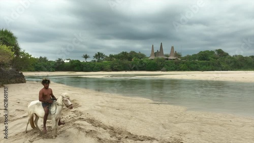 Marapu Sumba Tribe gracefully rides a horse along the shoreline