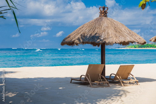 Fototapeta Naklejka Na Ścianę i Meble -  Chairs and umbrella at tropical beach with ocean. Holiday banner