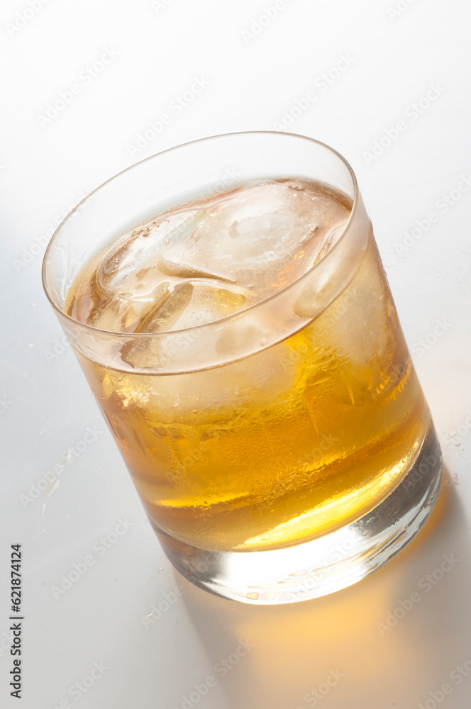 Crystal glass with whiskey and ice cubes on white background
Crystal glass with whiskey and ice cubes on white background