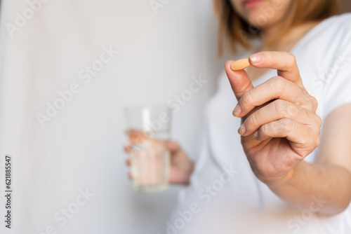 Pregnant woman are taking and eating vitamin medicine and drink water To nourish the pregnancy. Healthcare lifestyle concept.