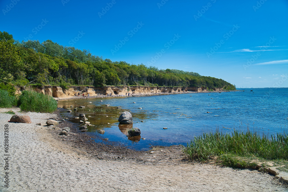 Bay on the island of Poel on the Baltic Sea. Stone beach, with trees on the coast