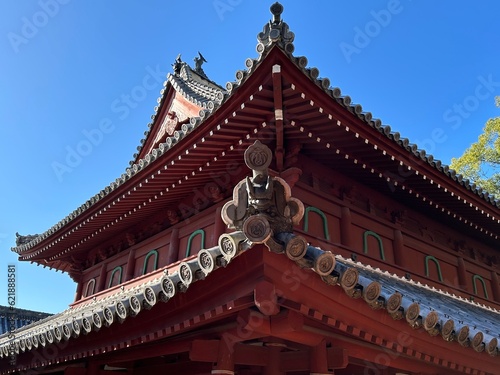 onigawara, ogre or demon tiles, temple roof ornamentation in Japanese architecture in Nagasaki Japan, chinese style architectural roof detail view