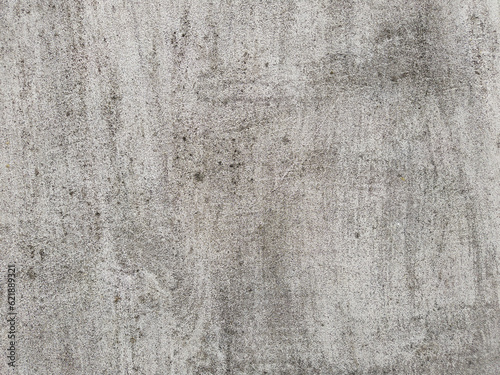 Damaged concrete wall background. An old gray cement surface with grunge texture.