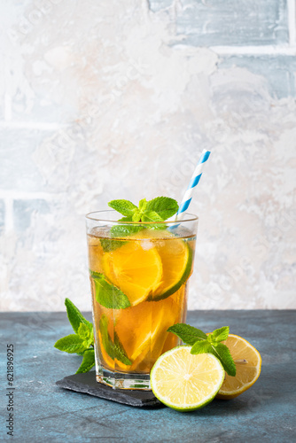 Iced tea with lemon, lime, mint and ice.