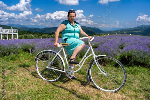 A woman on a bicycle in a lavender field. 