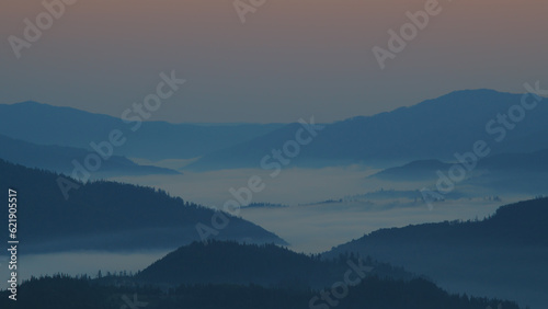 Carpathian mountains with fog at sunrise