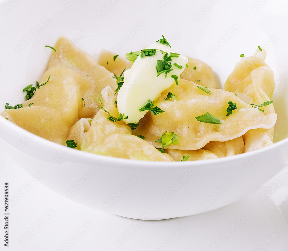 Delicious cooked dumplings and sour cream