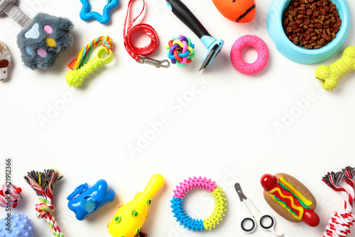 Frame borders made of pet toys and grooming accessories isolated on white background. Flat lay, top view. Pet shop banner template.