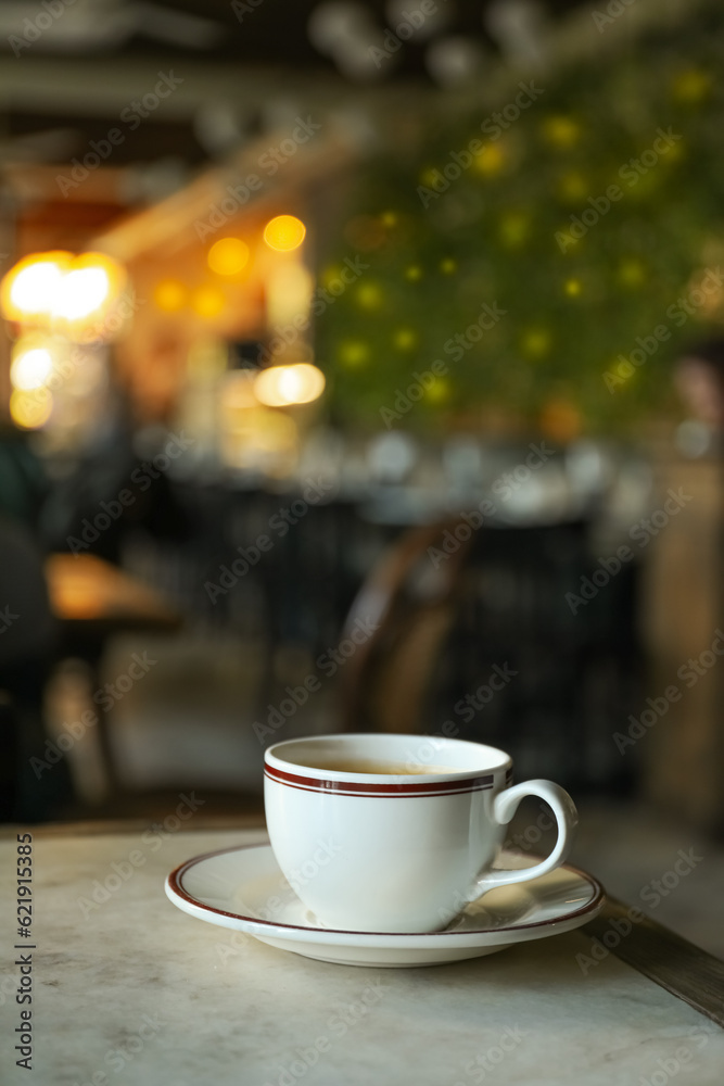 A cup of coffee on a table in a cafe A cup of coffee on a table in a cafe