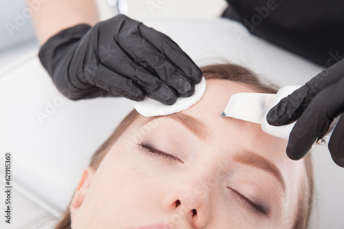 Patient of a beauty salon during facial treatments.