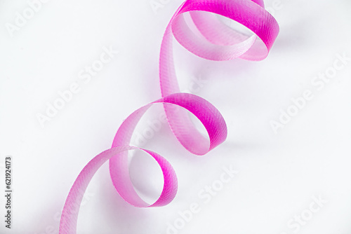 Pink ribbon for wrapping gifts on white background.