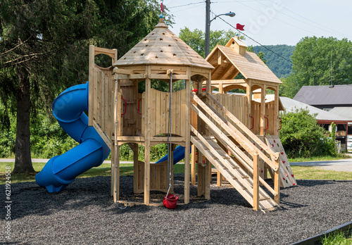 A new wooden playground set on King Street in Tidioute, Pennsylvania, USA on a sunny spring day photo