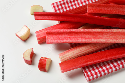 Rhubarb stalk on checkered towel on white background, close up