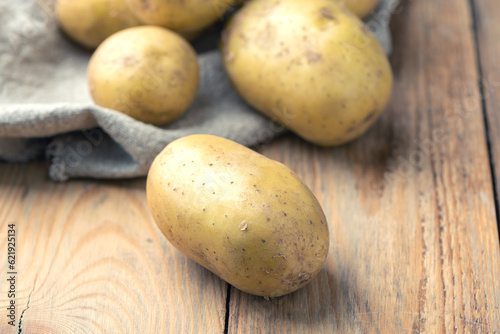 Close-up of ripe potatoes on a wooden background.