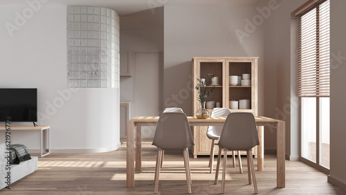 Minimal dining and living room in white tones. Bleached wooden table with chairs, glass block wall over kitchen. Cabinets and sofa. Scandinavian modern interior design