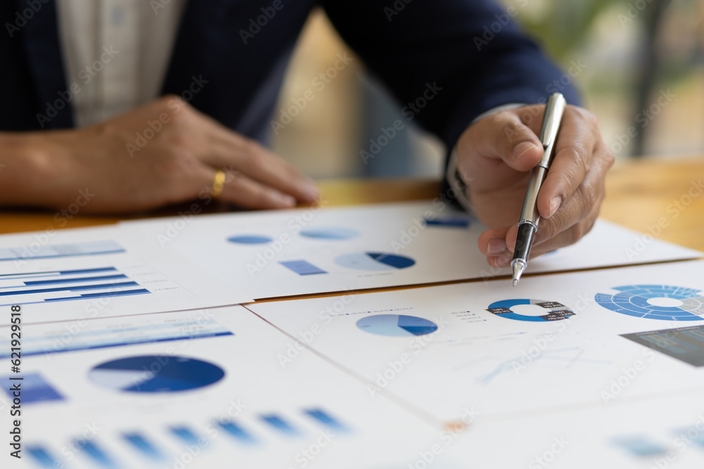Businessman working on documents on the desk, data analysis of financial figures and business investments.