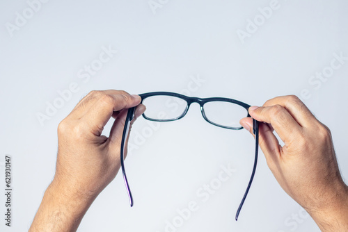 Male hands holding glasses, white background
