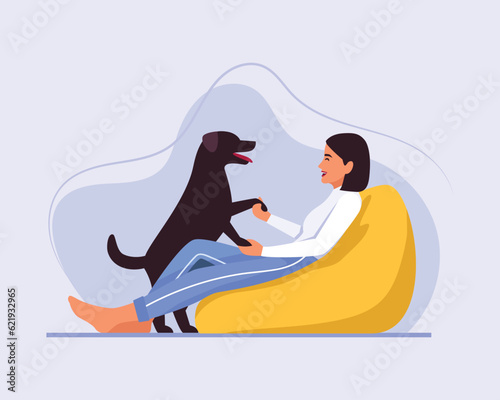 light-skinned girl with short hair sits on a bean bag chair with a dog	