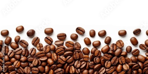 Roasted coffee beans spread over white background. coffee beans for quality drinks