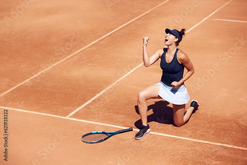 Top view image of young girl, professional tennis player showing emotions of win and success. Outdoor training. Concept of sport, hobby, active lifestyle, health, endurance and strength, ad © master1305