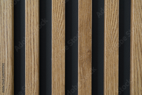 Wooden slats pattern on the wall. Home interior wood decoration, lamella panels texture.