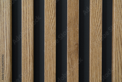 Wooden slats pattern on the wall. Home interior wood decoration, lamella panels texture.