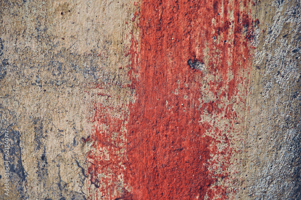 Fototapeta premium Grey, Abstract background of the shabby concrete wall surface with bright red yellow paint and mossy weathered parts