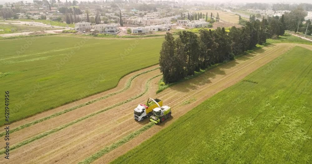 Aerial view of a agricultural machinery at action in a wheat field, Kibbutz Saar, Israel. Aerial view of a agricultural machinery at action in a wheat field, Kibbutz Saar, Israel.