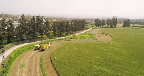 Aerial view of a agricultural machinery at action in a wheat field, Kibbutz Saar, Israel.