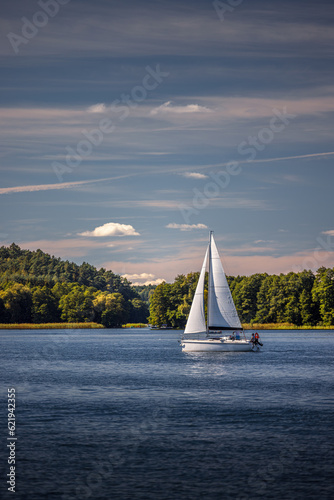 Sailboat on Lake Ukiel in Olsztyn. In the background isthmus 