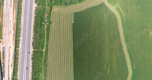 Aerial view of a agricultural machinery at action in a wheat field, Kibbutz Saar, Israel.