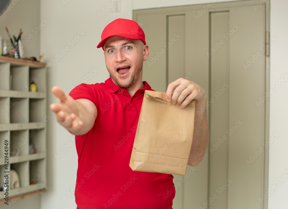 smiling happily and offering or showing a concept. delivery paper bag concept