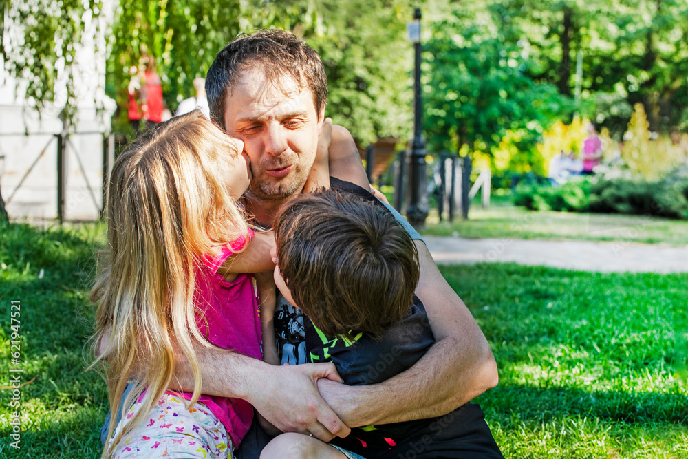 happy dad hugs children girl and boy in nature. Family holiday happy dad hugs children girl and boy in nature. Family holiday