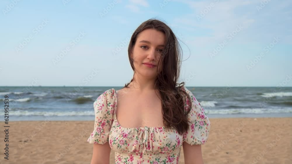 Young flirting attractive woman on seashore at beautiful sunset close up. Inspiration freedom. Relax leisure activity, active lifestyle, cheerful confident attractive girl Young flirting attractive woman on seashore at beautiful sunset close up. Inspiration freedom. Relax leisure activity, active lifestyle, cheerful confident attractive girl
