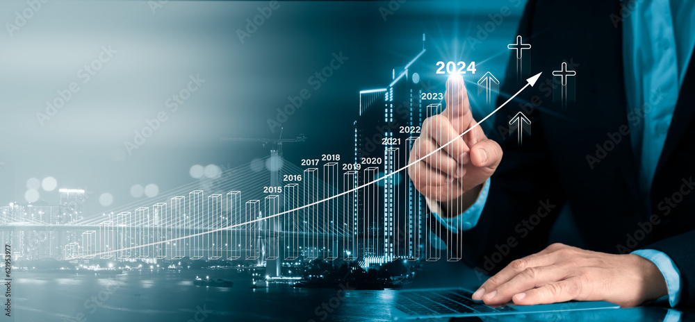 Fototapeta premium Businessman assessing financial data for long-term investments. Businessman new year business goals 2024. Businessman good indications 2024.