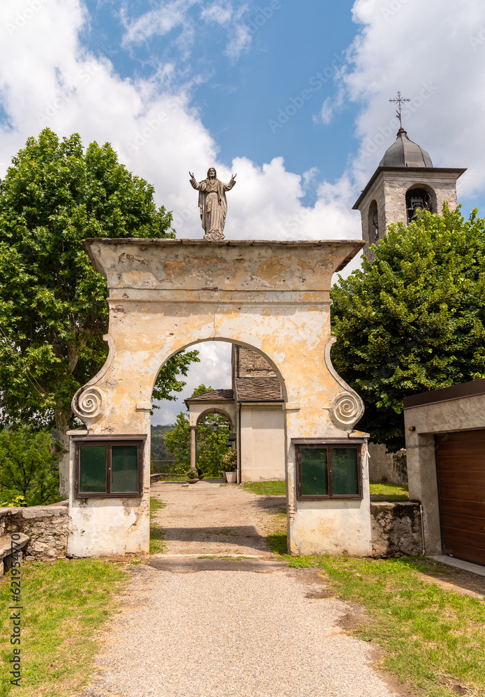 Naklejka premium Entrance arch to the ancient parish church of San Martino in the park of Oleggio Castello, province of Novara, Piedmont, Italy