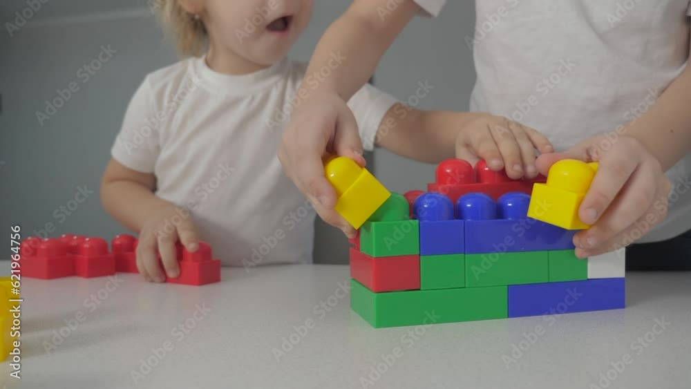 happy family boy and girl a collect constructor indoors teamwork. kids play toys concept. children brother and sister play collect house from constructor lifestyle happy family boy and girl a collect constructor indoors teamwork. kids play toys concept. children brother and sister play collect house from constructor lifestyle