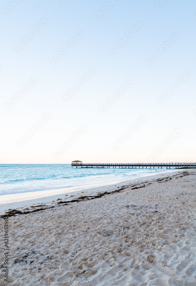 Sea coast. Calm sea. Sandy deserted beach. A bridge is visible in the distance. Light blue sea. Leisure, relaxation, tourism. Sea coast. Calm sea. Sandy deserted beach. A bridge is visible in the distance. Light blue sea. Leisure, relaxation, tourism.