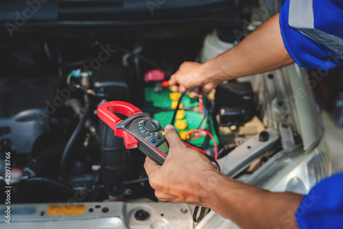 Equipment to check the battery with a mechanic to check and maintain the engine for customers. An app to write checklists for repair machines, car services and maintenance to the clipboard.