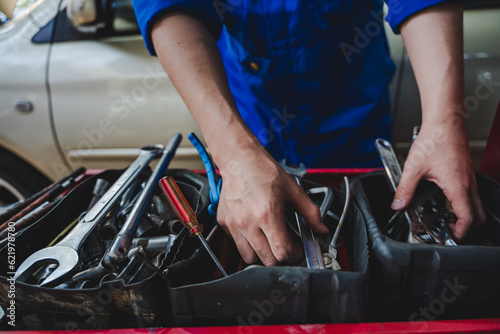 Auto repair equipment with mechanics to inspect and maintain the engine for customers An app to write checklists for repair machines, car services and maintenance to the clipboard.