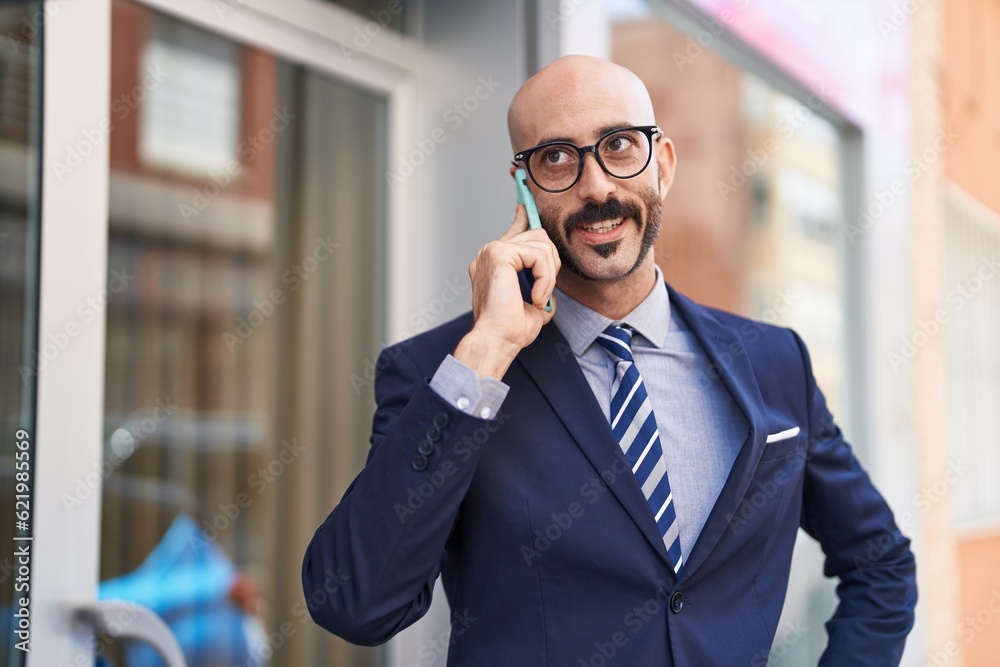 Young hispanic man executive smiling confident talking on smartphone at street Young hispanic man executive smiling confident talking on smartphone at street