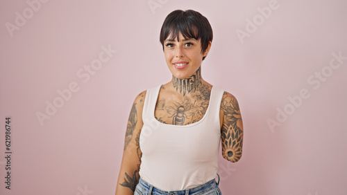 Hispanic woman with amputee arm smiling confident standing over isolated pink background photo