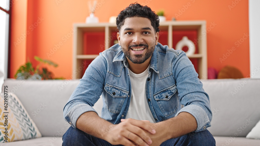 African american man smiling confident sitting on sofa speaking at home African american man smiling confident sitting on sofa speaking at home