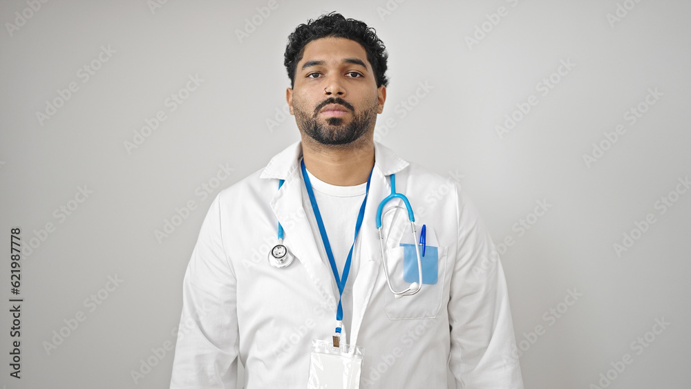 African american man doctor standing with serious expression over isolated white background African american man doctor standing with serious expression over isolated white background