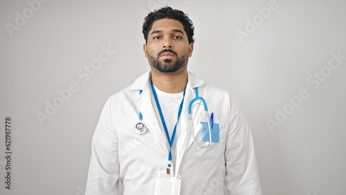 African american man doctor standing with serious expression over isolated white background