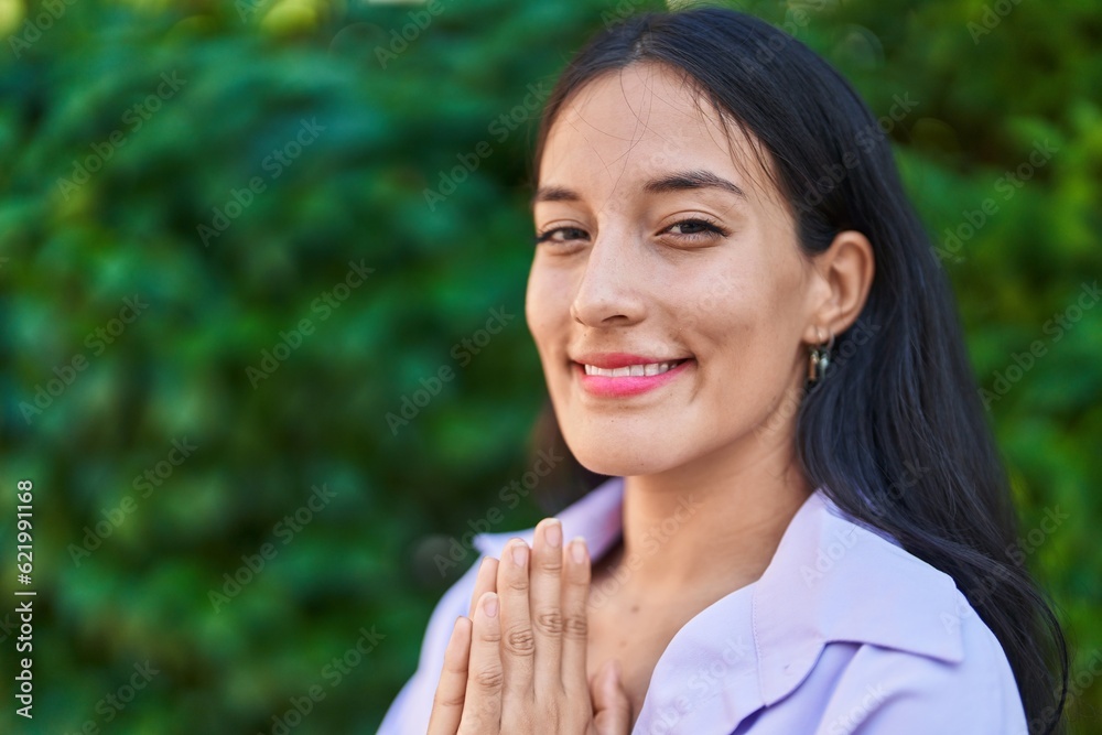 Young beautiful hispanic woman smiling confident doing yoga exercise at park Young beautiful hispanic woman smiling confident doing yoga exercise at park