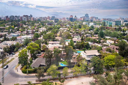 Elevated view from San Cristobal Hill of part of the upper middle-class neighborhoods of Las Condes and Vitacura, in the background the mountains of the Andes Cordillera. Santiago, Chile, Dec 2019 photo
